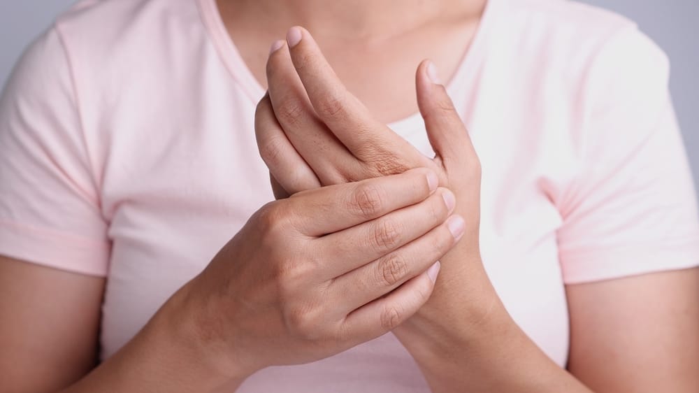 A person receiving an injection in the shoulder area from a medical professional wearing gloves - Trigger Point Injections